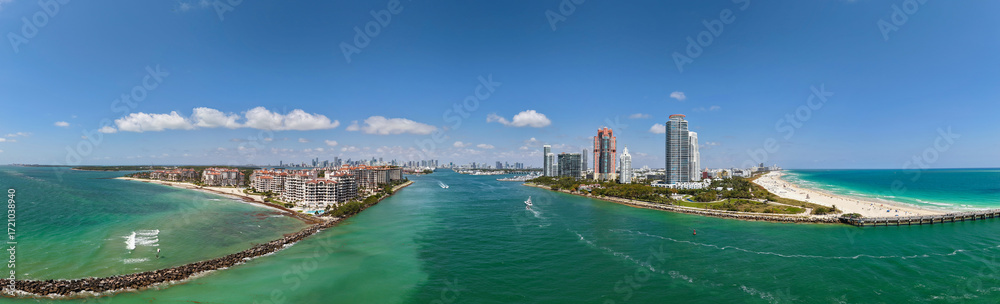 Obraz premium Panorama of Miami Beach with turquoise waters. Drone shot of Miami skyline. Top view of South Beach. Miami cityscape with luxury skyscrapers and ocean. View of Miami famous coastline.
