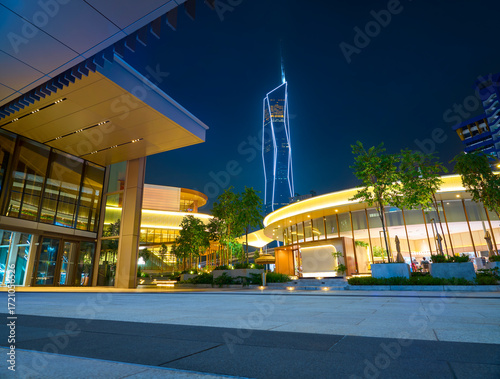 Urban plaza at night featuring modern illuminated architecture