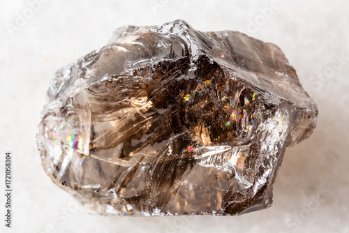 sample of raw smoky quartz rock on white marble