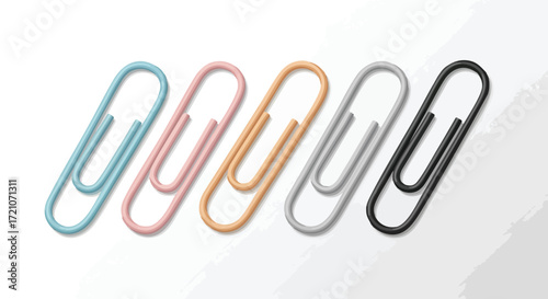 Colorful paper clips lined up on a white surface.