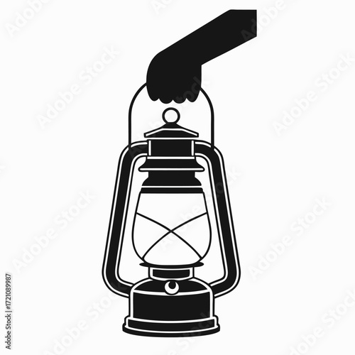 Hand holding old kerosene lantern lamp