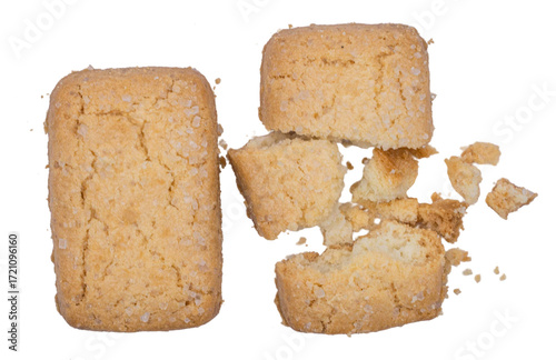 Crispy butter cookie with broken pieces and crumbs isolated on white background