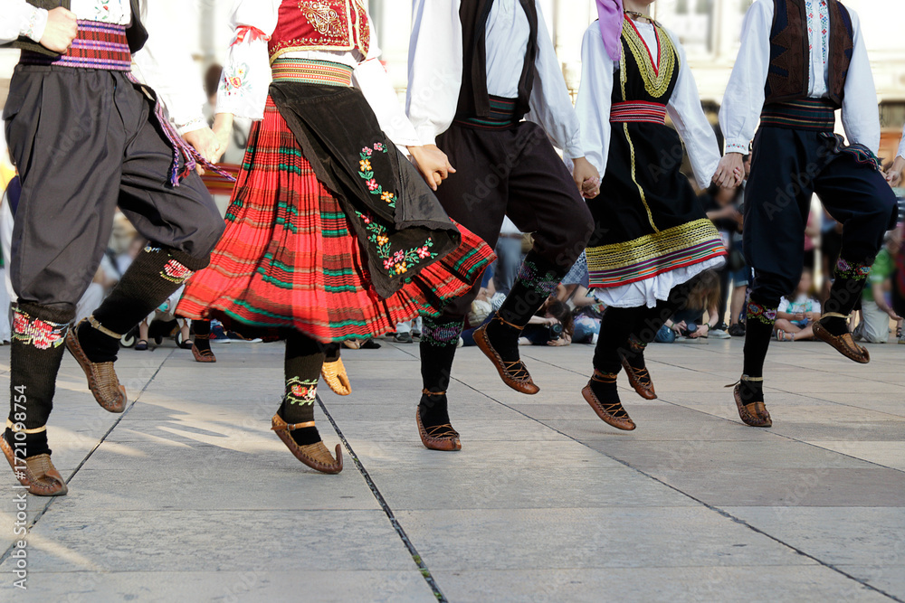 Obraz premium Dancers dancing and wearing one of the traditional folk costume from Uzide, Serbia