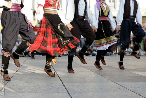 Dancers dancing and wearing one of the traditional folk costume from Uzide, Serbia