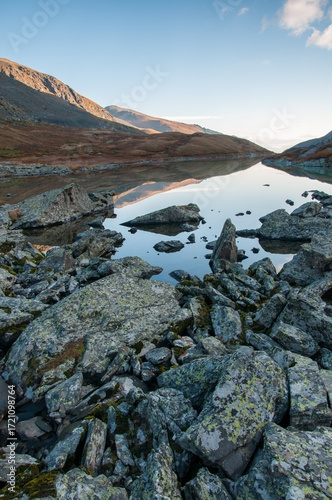 Morning view of lake Akchan in august with huge boulders on its shoreline, the Altai Republic, Russia