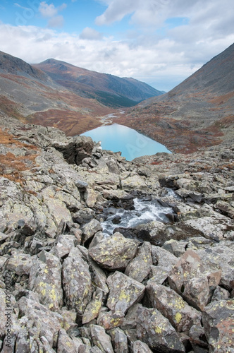 View on lake Akchan and part of Akchan valley with huge boulders in the foreground, the Altai Republic, Russia