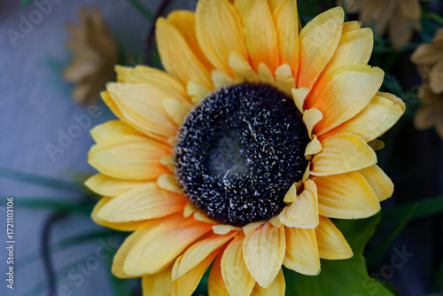 Bright sunflower decoration with vibrant yellow petals and dark center on display