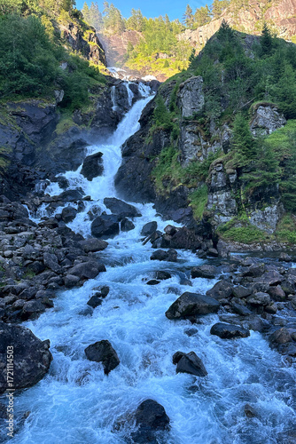 Vertical photo overlooking the Latefossen waterfall cascade at sunset near Skare in Norway
