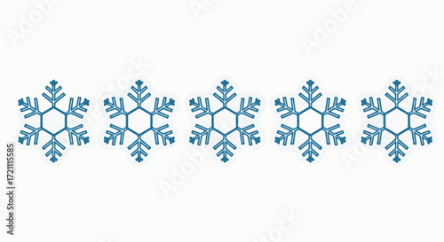 A simple and elegant decorative border made of a repeating pattern of blue snowflakes, isolated on a clean white background.