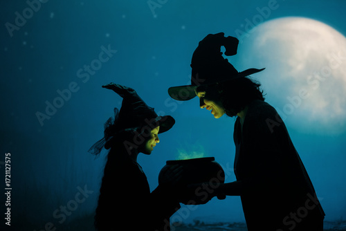 Woman and her daughter dressed in witch costumes