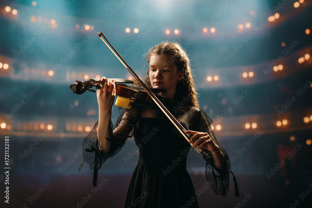 Fototapeta premium girl playing violin on stage