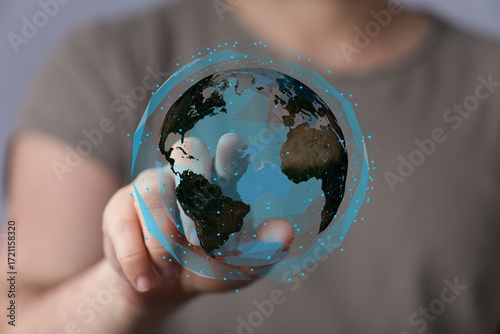 High-quality stock photo of a hand interacting with a digital globe, representing global connection and technology.