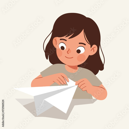 Child folds a paper airplane