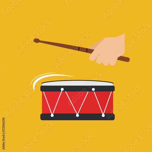 Hand holding drumstick above a red drum on a yellow background