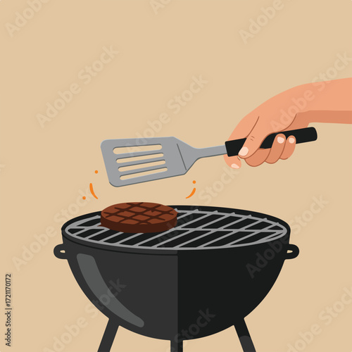 Burger on grill being flipped with spatula on a cream background