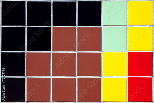 Tile background of multi coloured ceramic wall tiles with an abstract design pattern, geometric tiled backdrop stock photo image