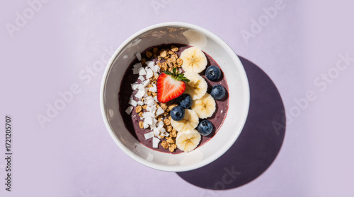 Acai bowl with fruit and granola on a pastel lavender background, clean top-down studio shot

