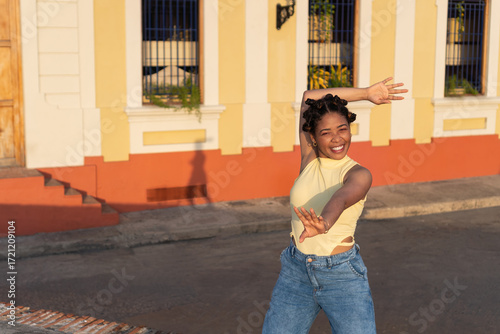 Young woman dancing expressing joy on urban street
