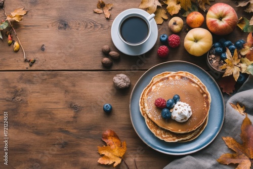 Pancakes and coffee on wooden table celebrating autumn