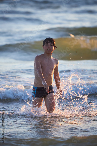 Wallpaper Mural Boy enjoys a sunny day at the beach Torontodigital.ca