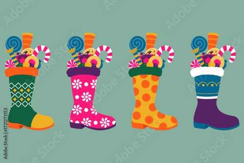 Collection of boots or Christmas stockings with fillers in them isolated on a teal background. Cute and colorful shoes filled with candy, toys and presents for gift giving