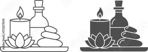 Serene spa arrangement with lit candle, essential oil bottle, stacked stones, and lotus flower