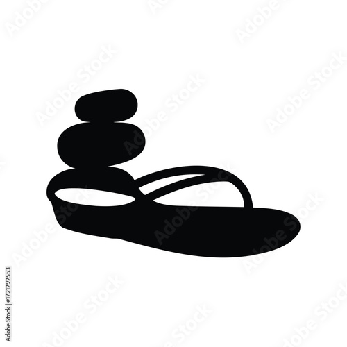 Stylized black silhouette of stacked stones on top of a flip flop