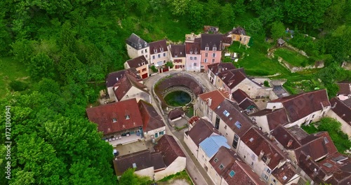 Aerial view of ancient town of Tonnerre with unusual water reservoir Fosse Dionne. Burgundy France