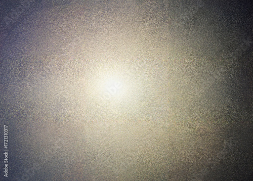 Close-up of metallic textured surface with grainy pattern and light reflection in center