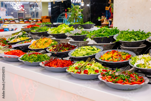 Mediterranean cuisine, olive oil, healthy and delicious salad varieties with green vegetables.Vegetarian and vegan healty food, open buffet in a luxury hotel. Meze varieties, salad bar.