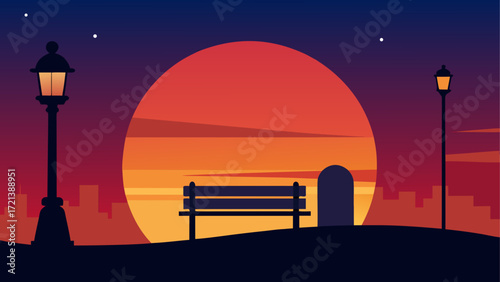 Silhouette of a bench and lamps against a sunset with city buildings in the background at dusk time