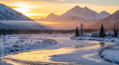 Fototapeta Naklejka Na Ścianę i Meble -  A winter landscape with a river flowing through a snowy valley and mountains at sunset time view