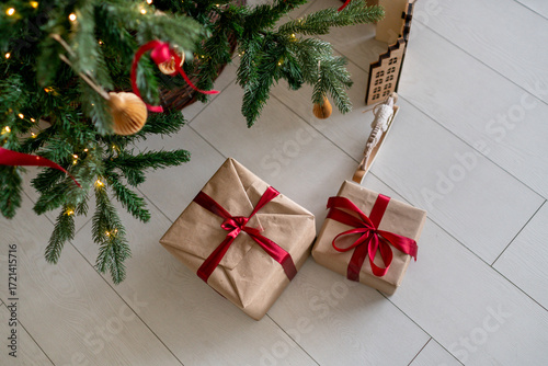 Christmas decorations: paper-wrapped gifts under the christmas tree.