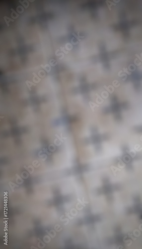 This is a blurry, abstract, and out-of-focus image of a patterned surface.
