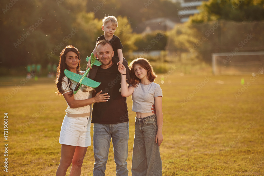 Fototapeta premium Photo of happy family with husband, wife and two kids