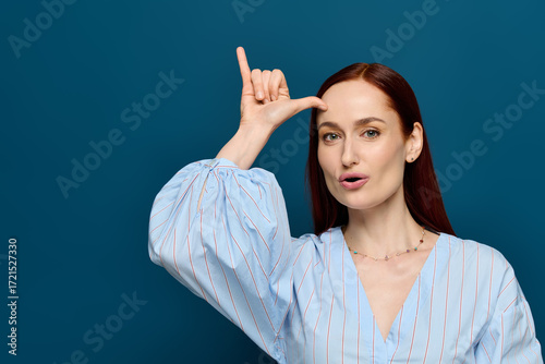 Fotografie Red-haired language teacher demonstrates sign language with enthusiasm