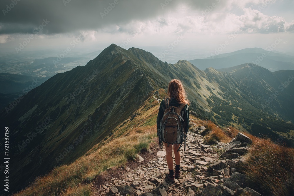 Obraz premium Hiker Standing on Mountain Ridge Trail