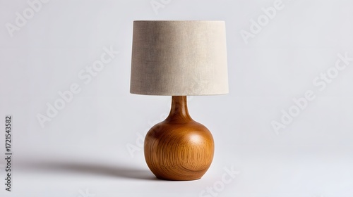 A simple and elegant wooden table lamp with a neutral-colored fabric shade, creating a warm and inviting ambiance.