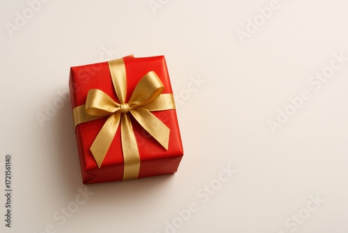 Festive Red Gift Box with Golden Ribbon on White Background.