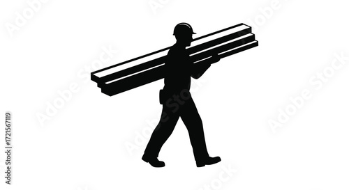 Silhouette of a worker carrying lumber on his shoulder