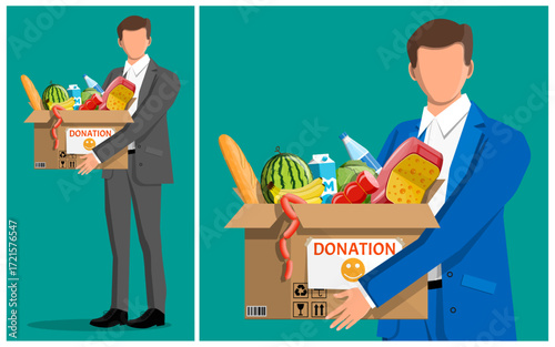 Man in suit holding box with food donation. Charity and support concept. Helping people in need with provisions.