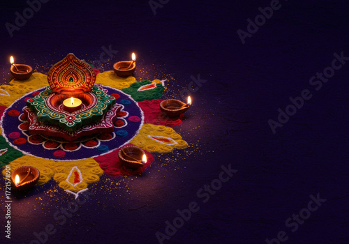 Simple background for Diwali or Deepavali of Hindu celebration, the festival of lights. With Diyas (oil lamp) and Rangoli. Copy space.