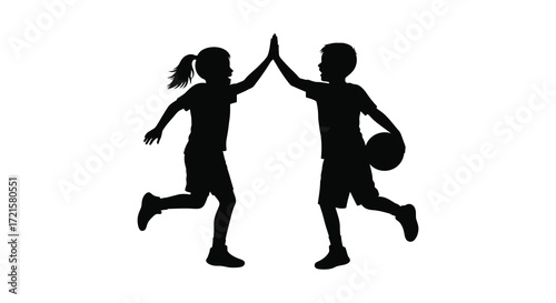 Silhouette of two children celebrating with a high five and basketball