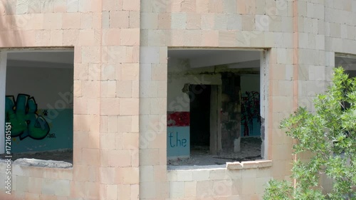 Unoccupied, empty, deserted, Industrial building in nature. Aerial view abandoned building in forest. Ruins near green trees.
