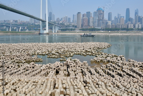 On September 21, 2022, along Nanbin Road in Nan'an District, Chongqing, China, the receding waters of the Yangtze River exposed the boulders of the breakwater near the yacht marina, creating a rather 