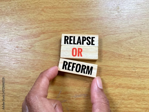 Three wooden toy blocks labeled with word Relapse Or Reform.