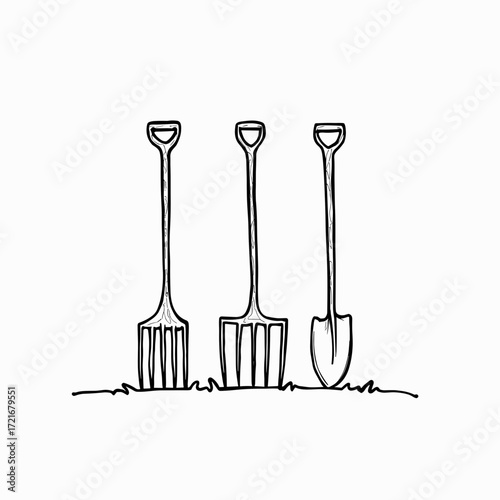 Three gardening tools including a fork and shovels on grass  