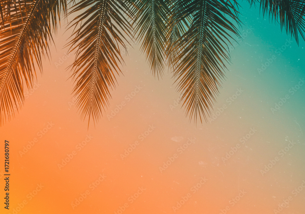 Fototapeta premium Dreamy sunset sky with silhouetted palm fronds evokes tropical paradise vibes and serene vacation escapes