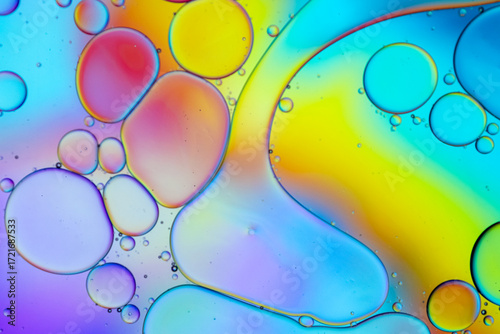 Close up of oil drops on water surface. Colorful abstract macro background of oil drops on water surface with air bubbles inside. Colorful background for gadget and computer wallpaper