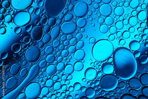Close up of oil drops on water surface. Colorful abstract macro background of oil drops on water surface with air bubbles inside. Colorful background for gadget and computer wallpaper